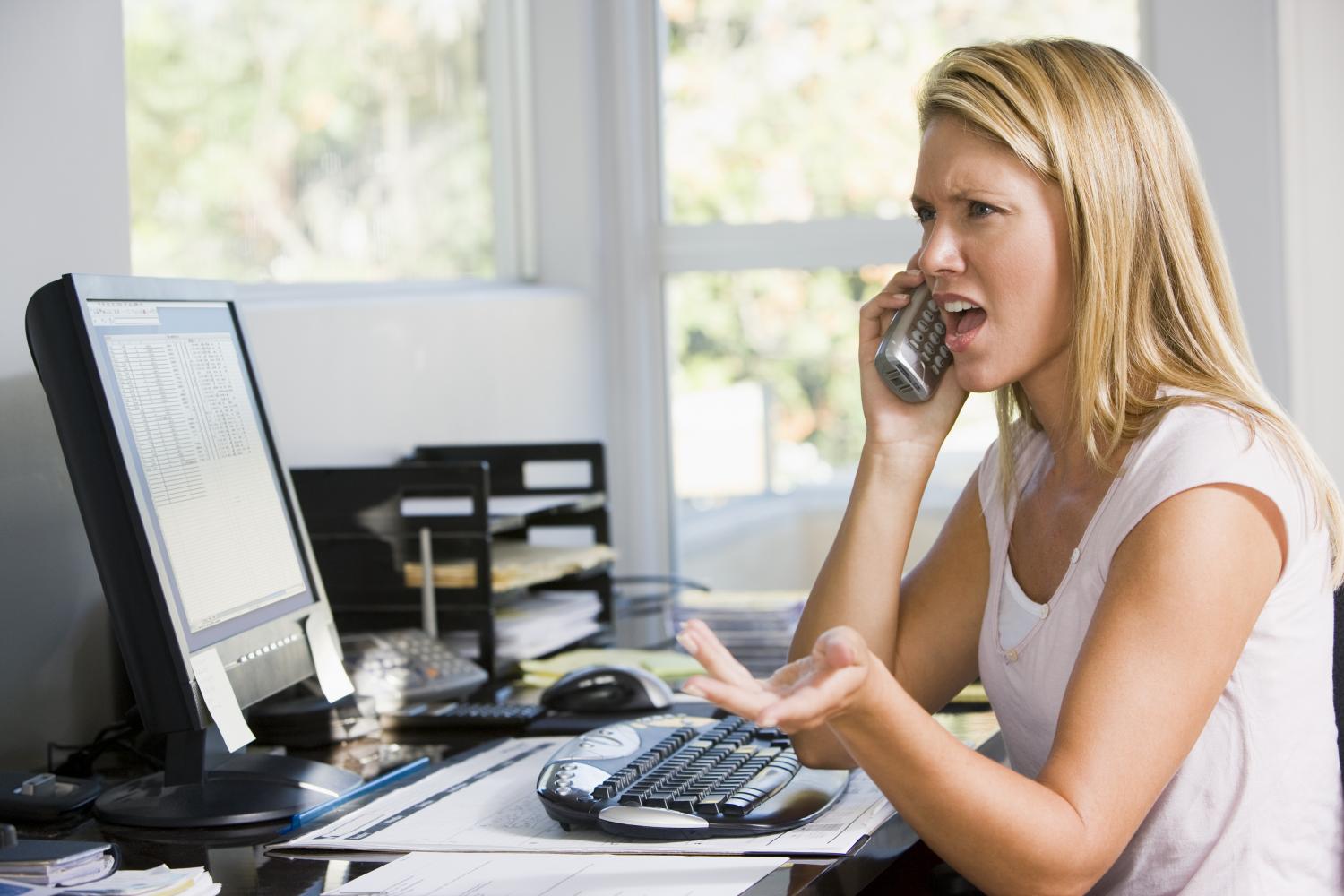 Lady unhappy with response from person on the other end of the phone that she is talking to.