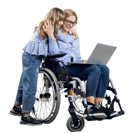 Little girl hugging a lady in a wheel chair looking at a laptop.